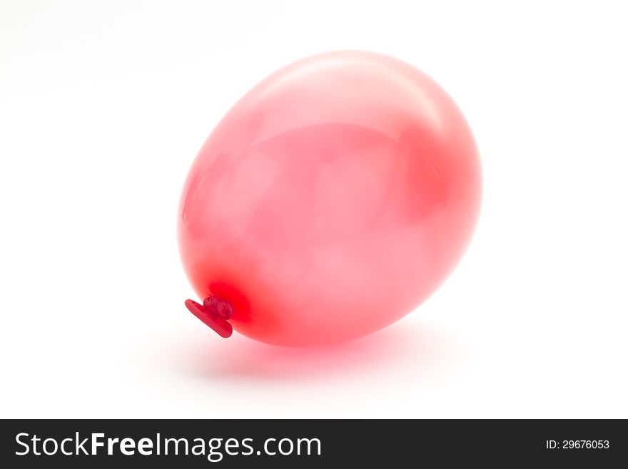 Single red small balloon macro isolated on white
