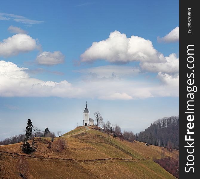 Little white church on a top hill under blue sky. Little white church on a top hill under blue sky