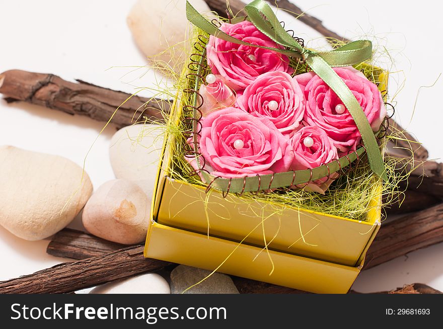 A box of beautiful red roses with wood and stones unde. A box of beautiful red roses with wood and stones unde