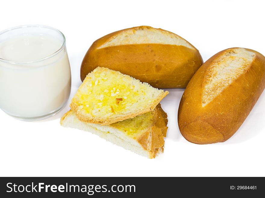 Two loaves of french baguette and a glass of milk and garlic bread, on white background. Two loaves of french baguette and a glass of milk and garlic bread, on white background