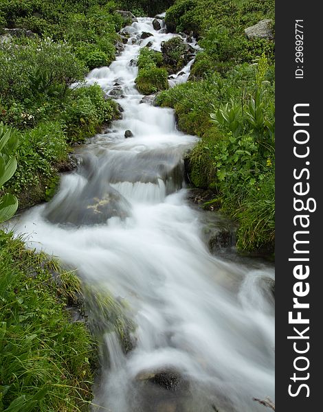 Rapid mountain stream whith warefall. Caucasus