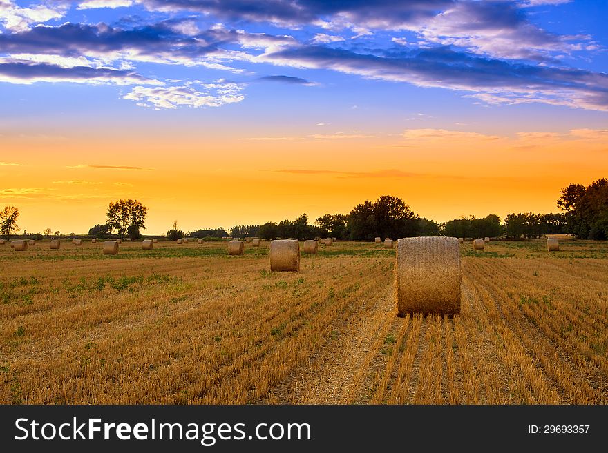 End of day over field with hay bale in Hungary- this photo made by HDR technic. End of day over field with hay bale in Hungary- this photo made by HDR technic