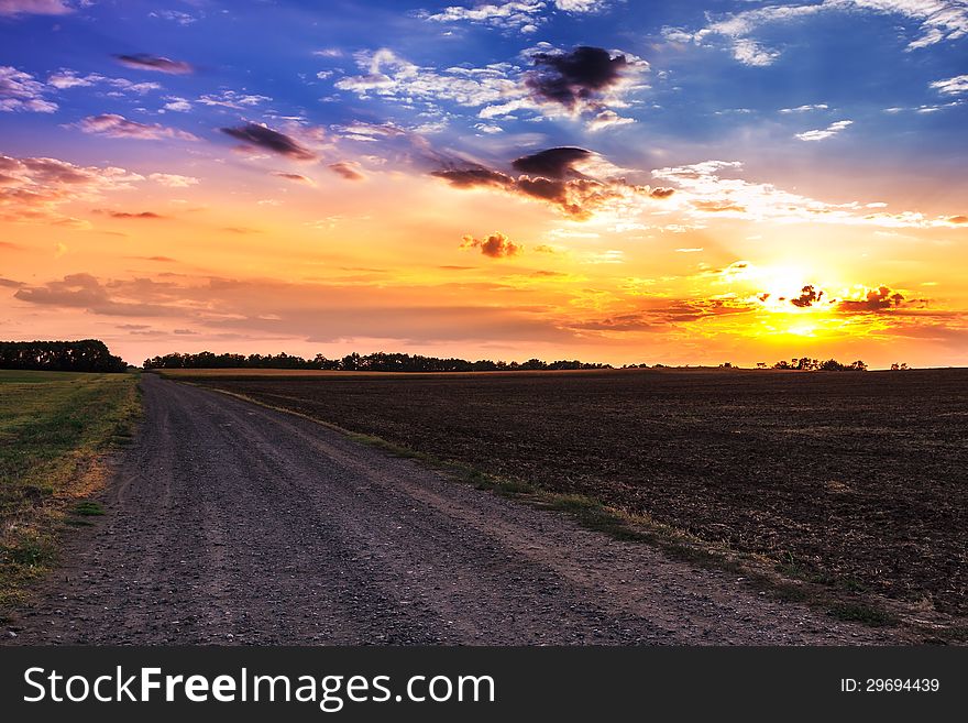Sunset and rural road in summer. Sunset and rural road in summer
