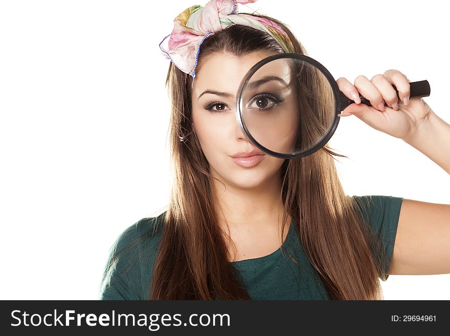 Nice and beautiful girl looking through a magnifying glass. Nice and beautiful girl looking through a magnifying glass