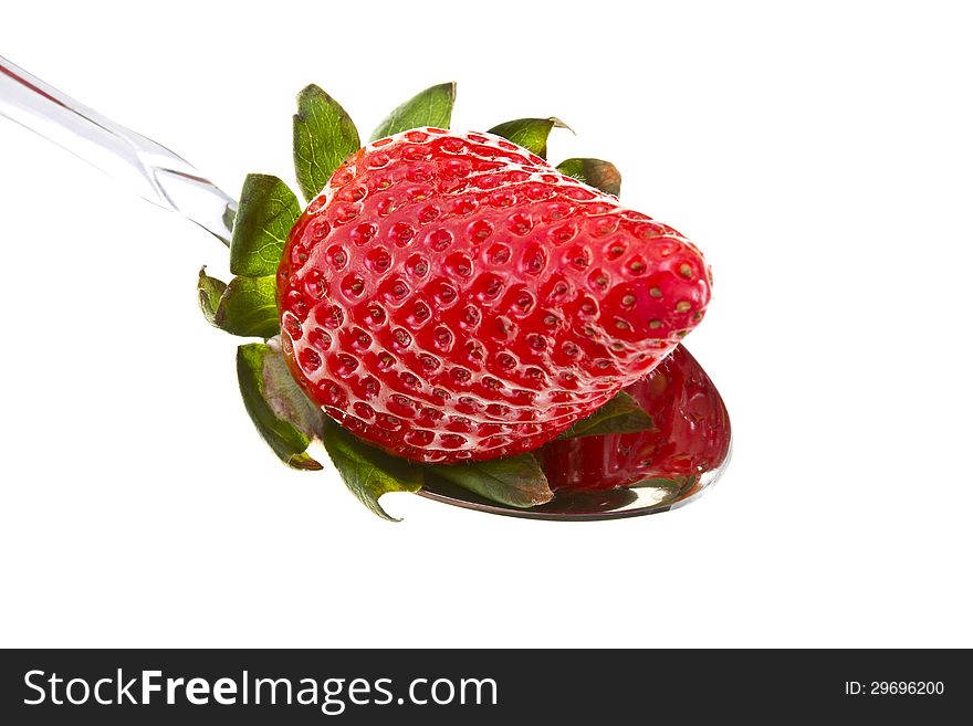 Tasty strawberry inside of a metal spoon isolated on white