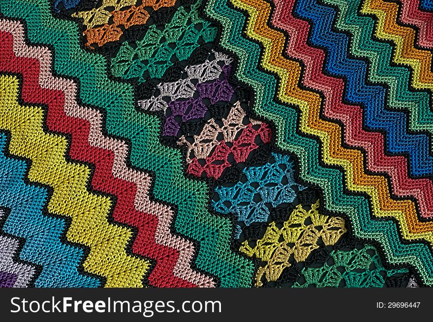 Detail of colorful knitted blankets pillows. Detail of colorful knitted blankets pillows