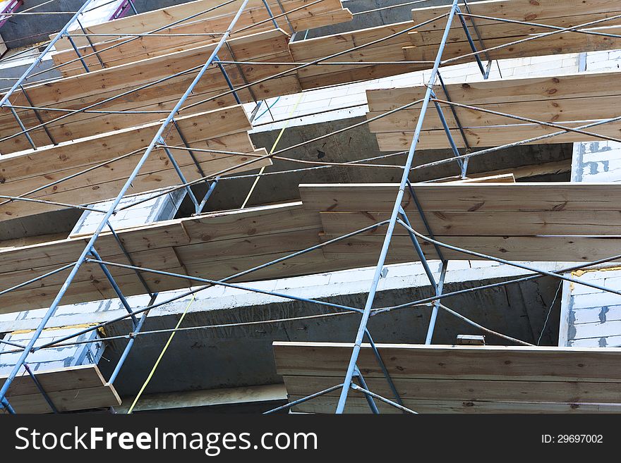 Concrete wall of construction building with scaffolding. Concrete wall of construction building with scaffolding