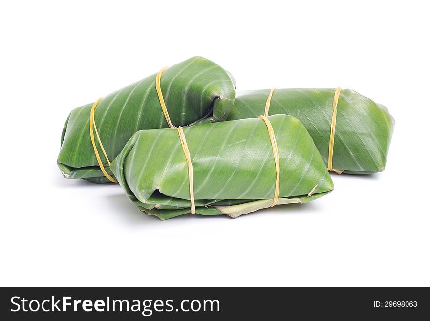 Sour pork in banana leaf on white background