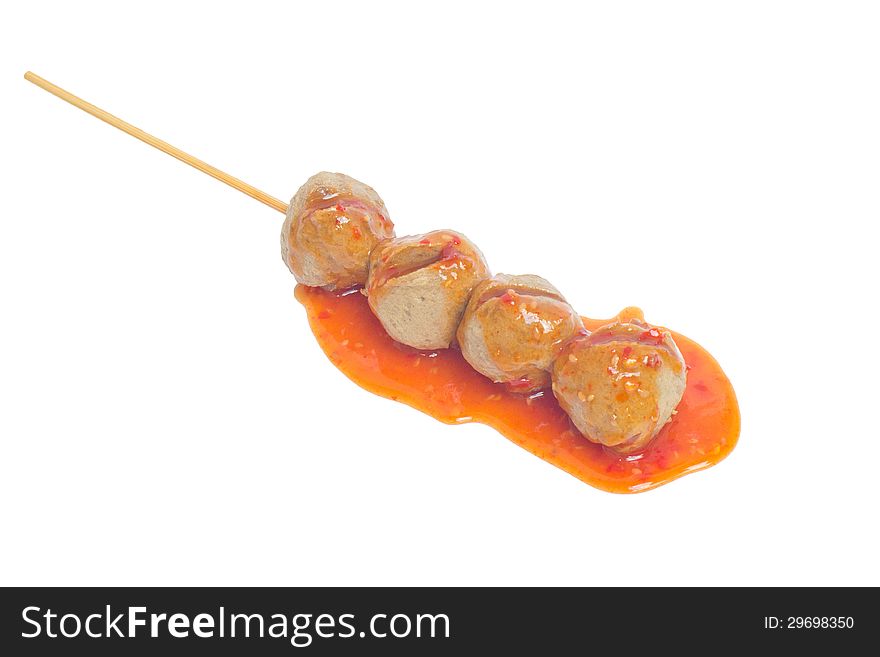 Closeup of thai meatballs with sauce on white background