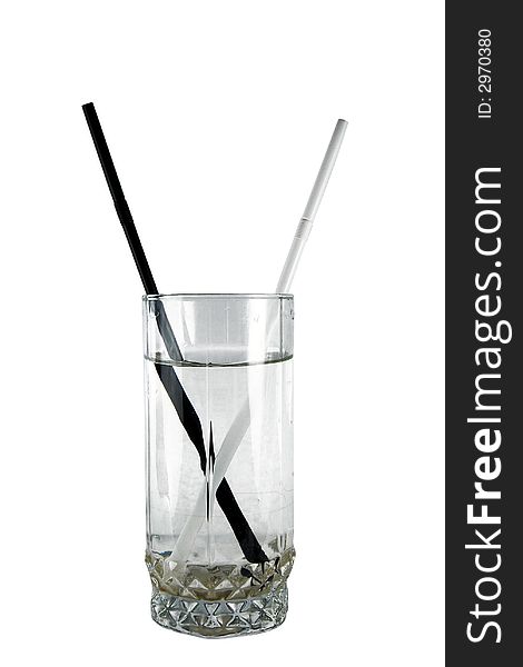 Black and white straws in glass on insulated background. Black and white straws in glass on insulated background
