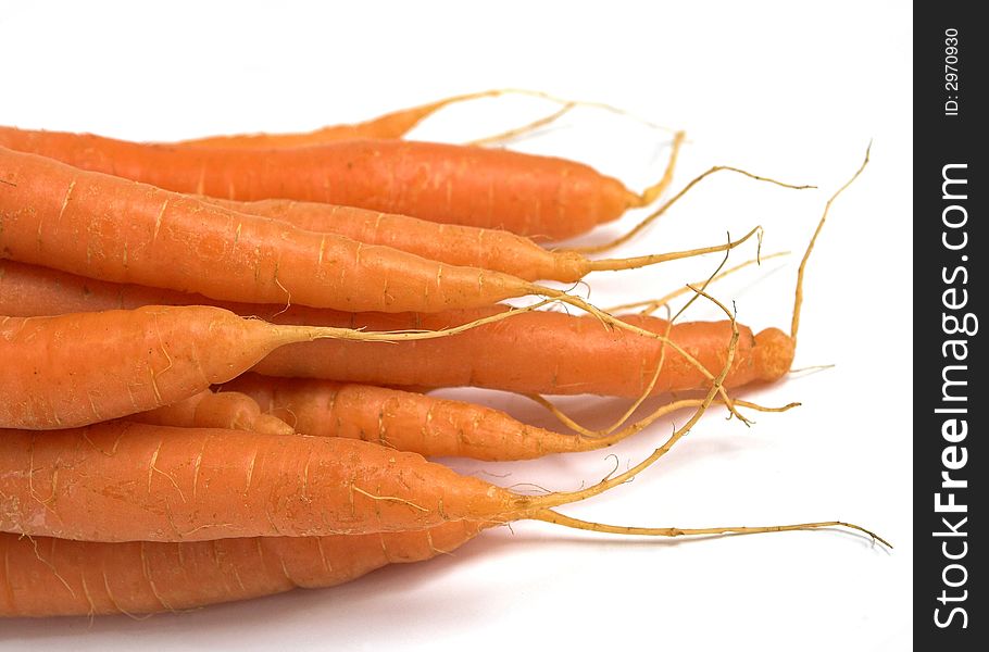 Macro detail of some organic carrots on a white background. Macro detail of some organic carrots on a white background.