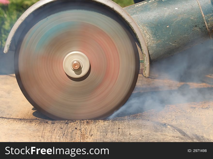 Power grinder cutting through plastic