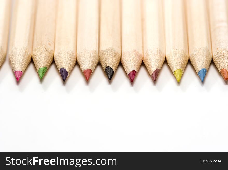 Wooden color pencils in line isolated on white