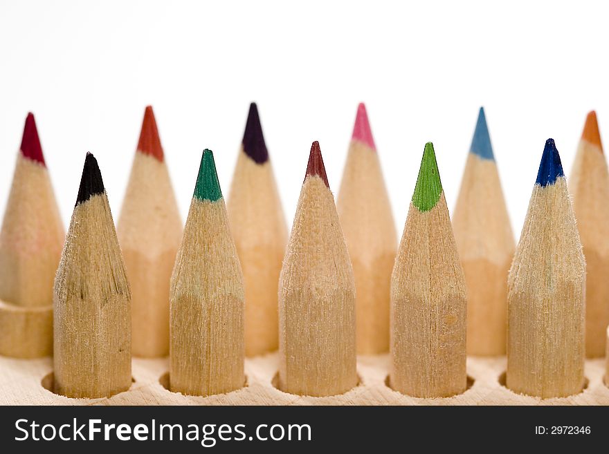 Wooden color pencils in line isolated on white