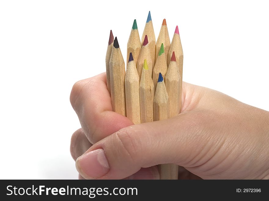 Hand holding wooden colored pencils isolated on white. Hand holding wooden colored pencils isolated on white