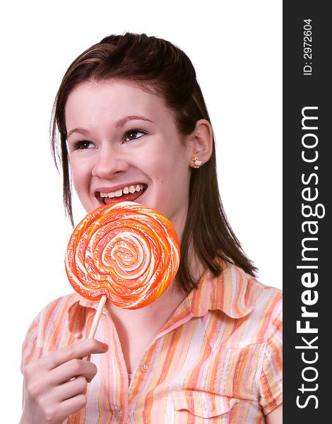 Happy teen licking a giant orange lollypop.  Isolated on white. Happy teen licking a giant orange lollypop.  Isolated on white.