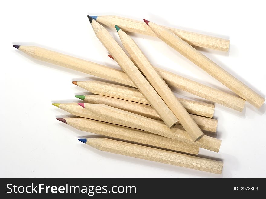 Wooden color pencils in stack isolated on white