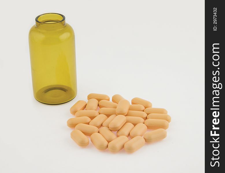 Pills and bottle on white background