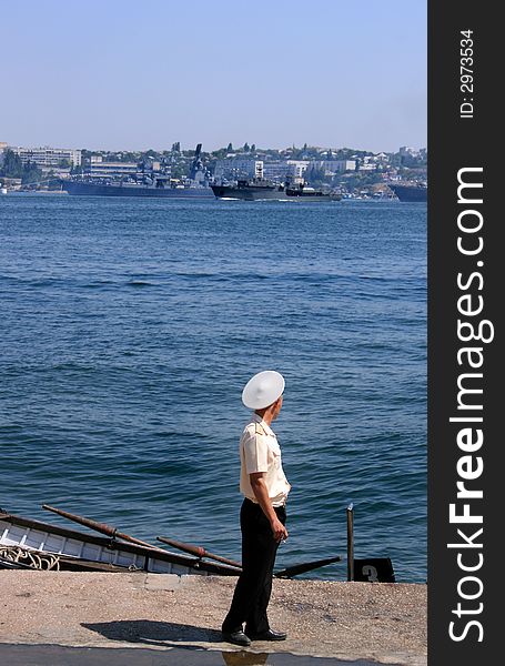 Sea officer looking at navy ships