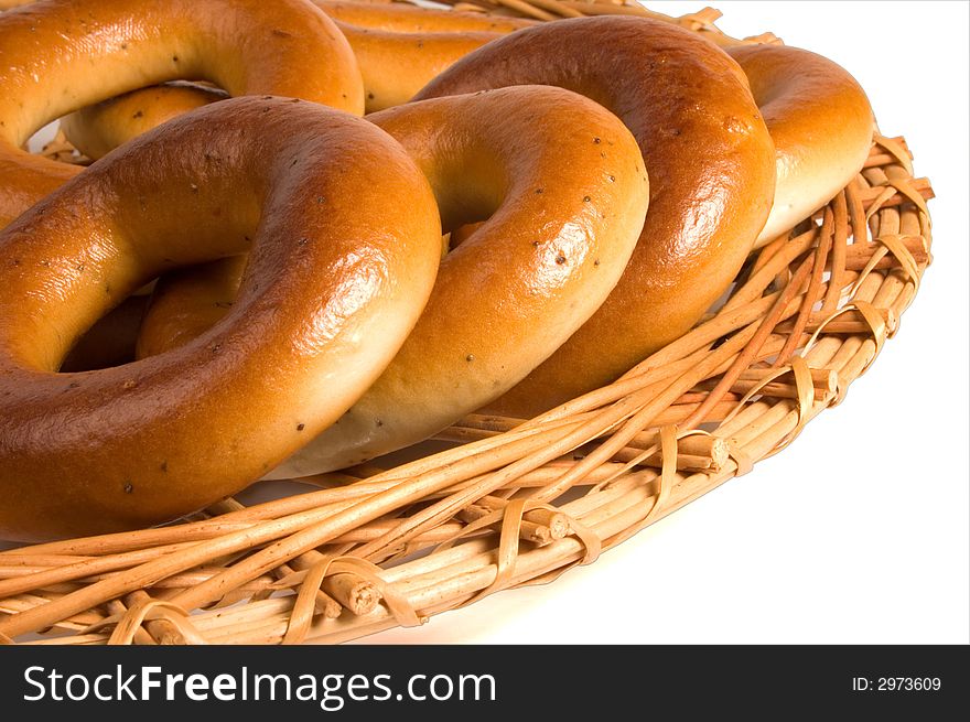 Appetizing bagels on wicker plate at the table