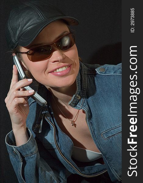 Lady in black glasses talking by mobile phone. Lady in black glasses talking by mobile phone
