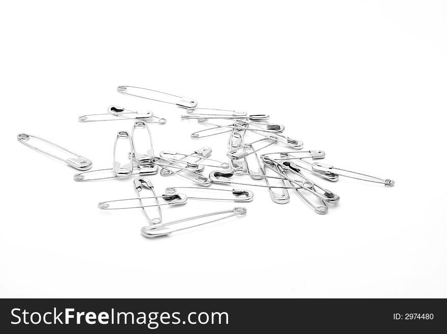 Saftey pins, scattered on a white background. Saftey pins, scattered on a white background