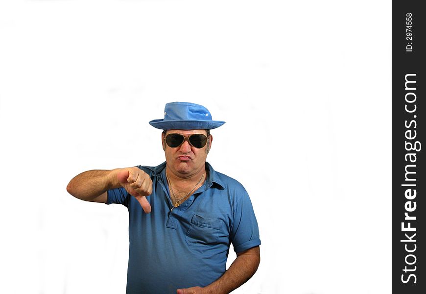 A man wearing a hat and sunglasses pointing his thumb down, over white. A man wearing a hat and sunglasses pointing his thumb down, over white