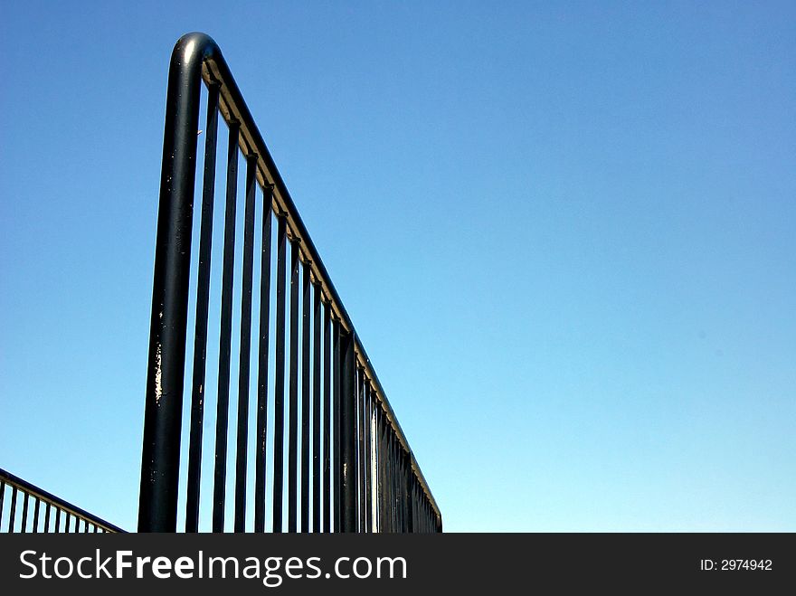 Playground railing shot from a low angle fading off into the distance