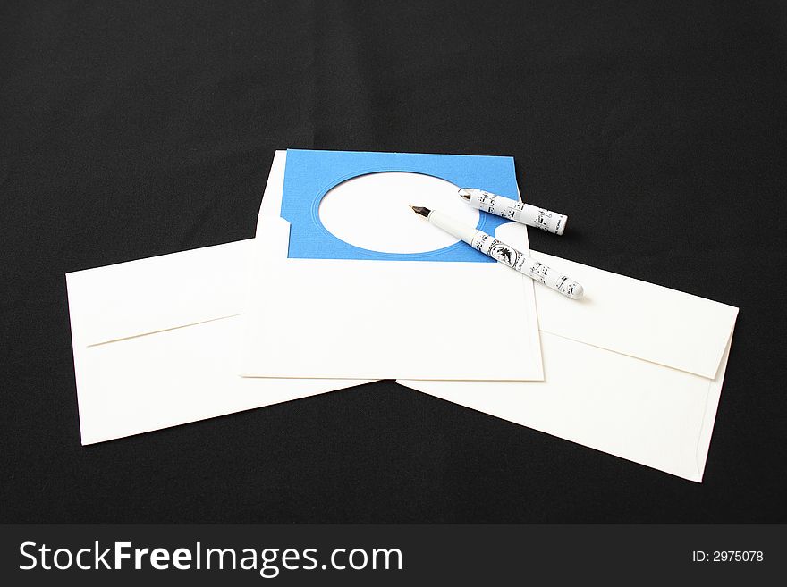 On a photo on a black background white envelopes, a card. On a photo on a black background white envelopes, a card