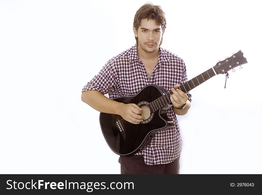 A young handsome boy playing acoustic guitar - isolated. A young handsome boy playing acoustic guitar - isolated