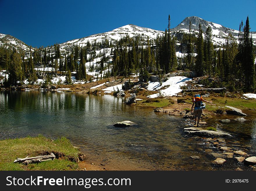 An alpine lake backdropped by snowcapped peaks. An alpine lake backdropped by snowcapped peaks