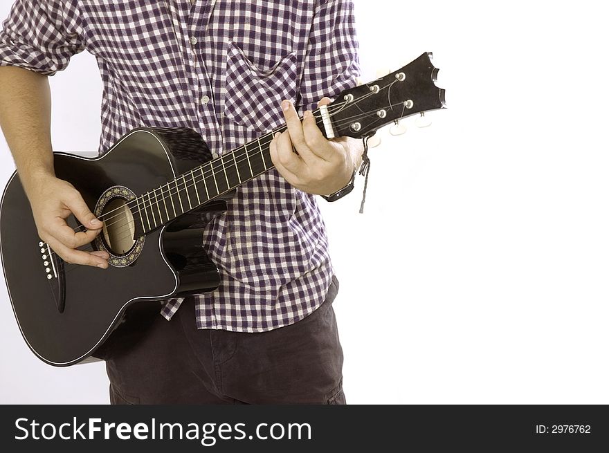 A young male playing acoustic guitar - isolated. A young male playing acoustic guitar - isolated