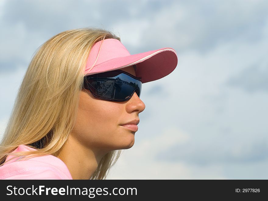 The beautiful young woman on a background of sky. The beautiful young woman on a background of sky