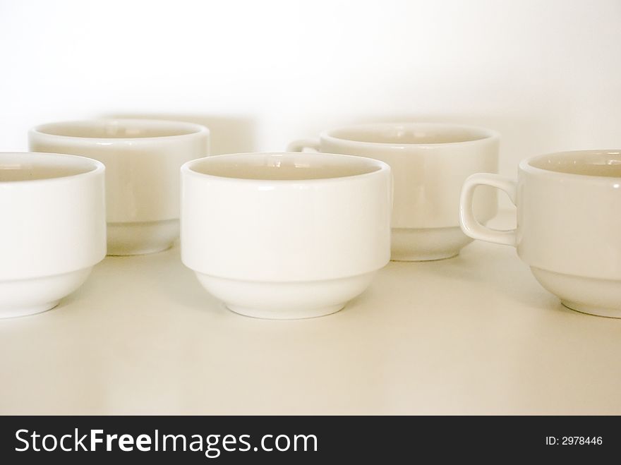 Empty Coffee Cups waiting to be filled. Focus on back lip of cup. Shallow depth of field