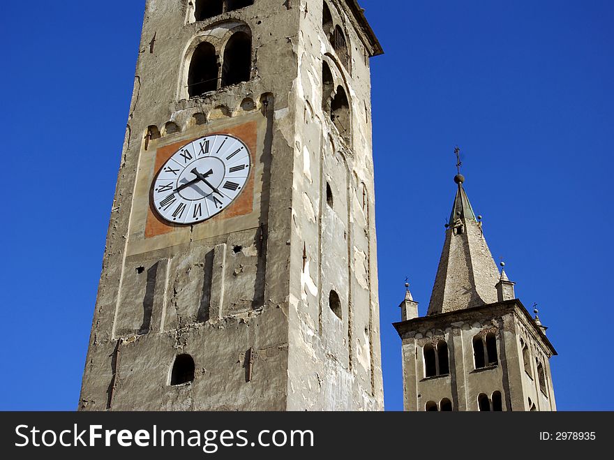 Details of clock tower of a very old church in Aosta, Italy. Details of clock tower of a very old church in Aosta, Italy.