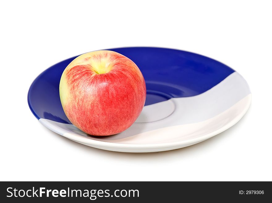 Red apple on the plate isolated on white background.