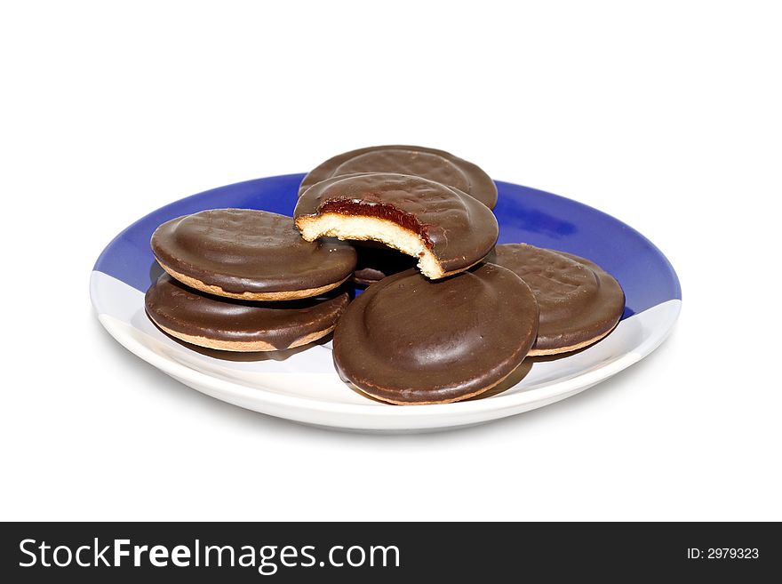A pile of chocolate cookies on the plate, isolated on white background.