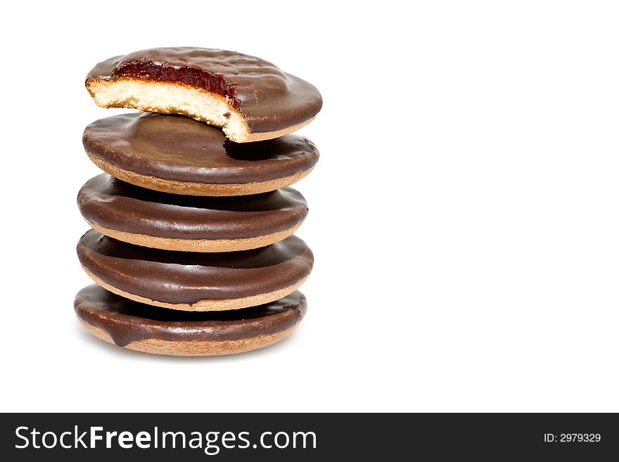 A pile of chocolate cookies isolated on white background. Copyspace provided.