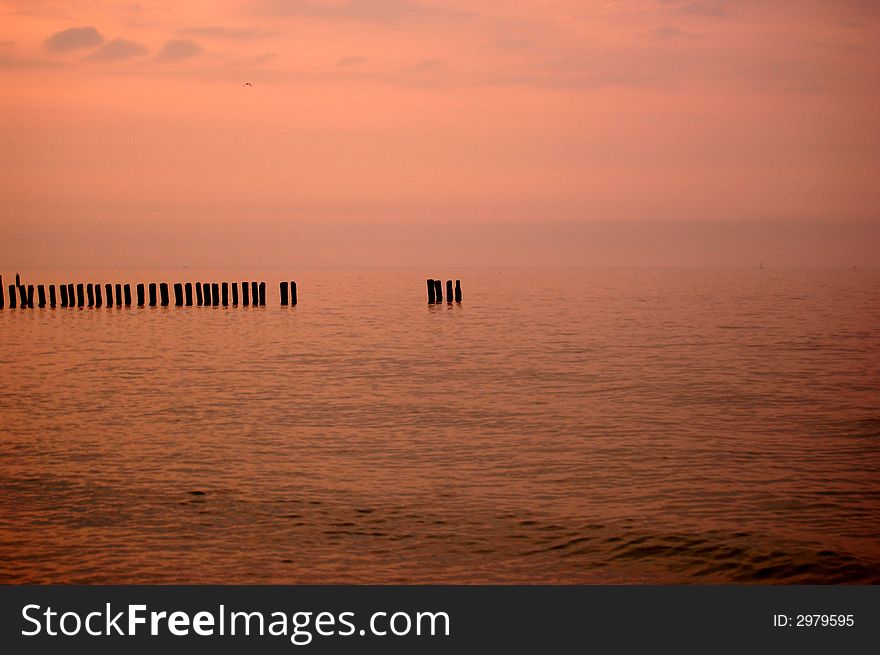 Beautiful sunrise on a beach with Storm Defences. Baltic Sea, Poland.