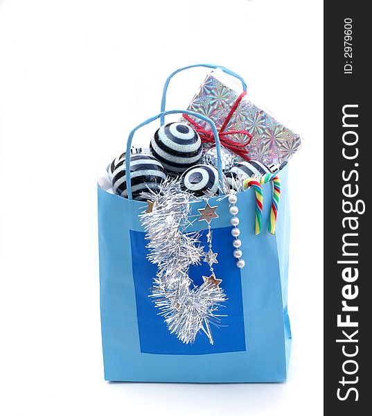 Christmas present and some ornaments in blue paper bag. Christmas present and some ornaments in blue paper bag.