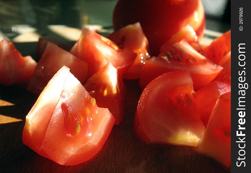 Chopped red tomatoes in different sized pieces. Chopped red tomatoes in different sized pieces