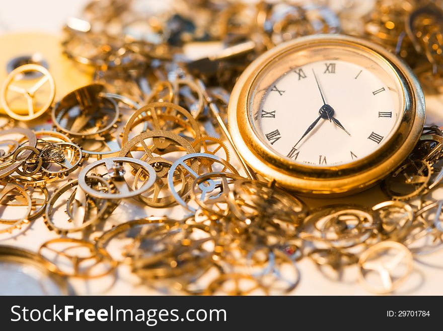 A watch face surrounded by tiny clock gears. A watch face surrounded by tiny clock gears.