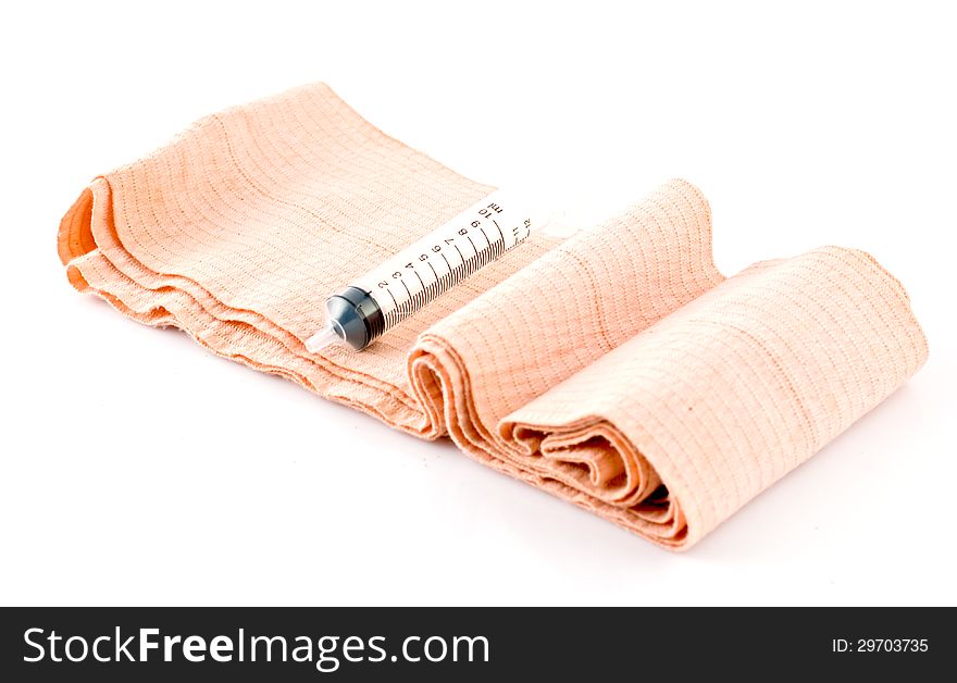 Elastic Bandage and Plastic Syringe on white background. Elastic Bandage and Plastic Syringe on white background