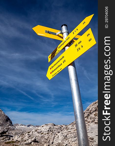 Yellow sign-board against mountain scenery