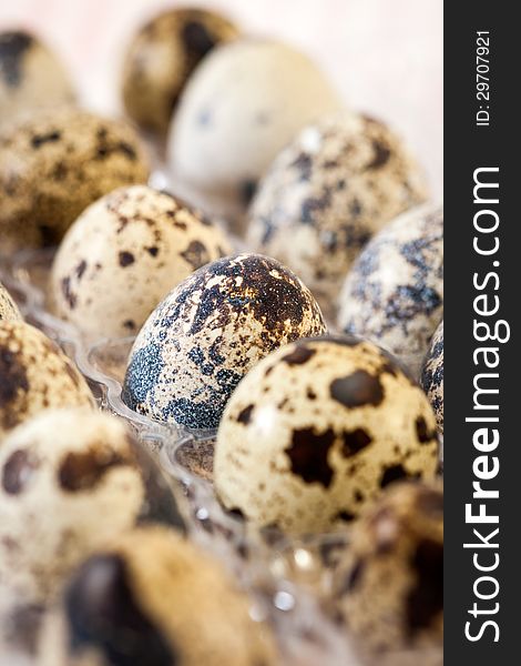 Quail eggs in a wooden bowl