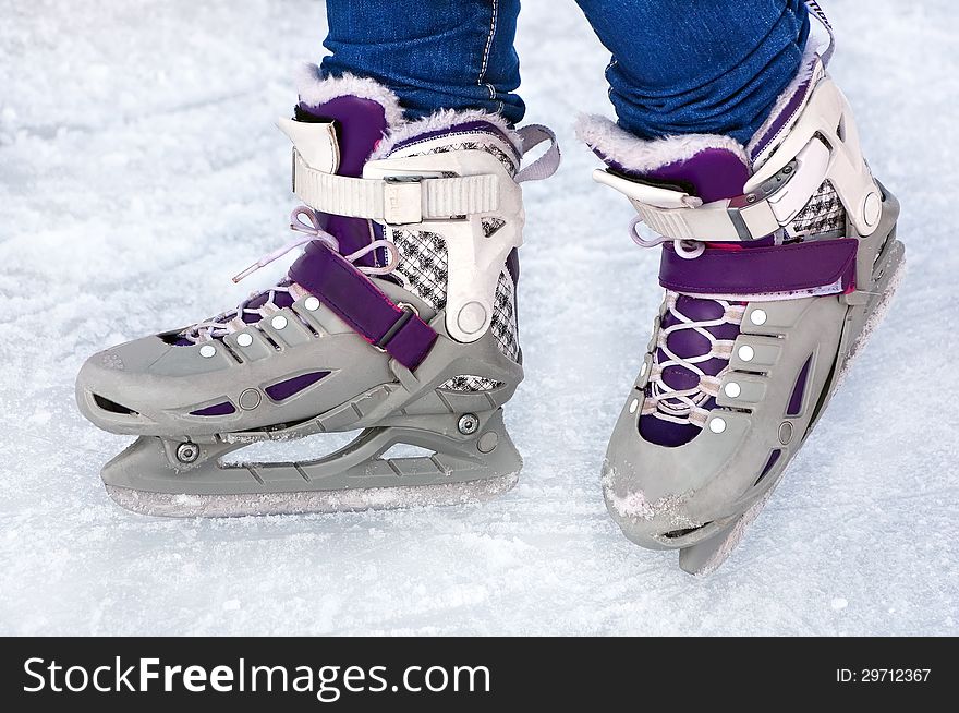 Feet in the figure skaters performing on ice. Feet in the figure skaters performing on ice