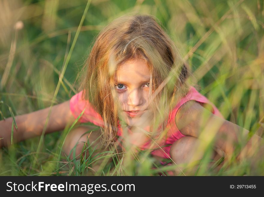 Girl sitting in the grass. Girl sitting in the grass