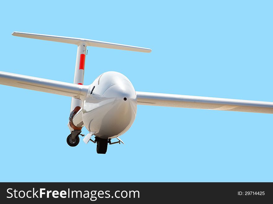 White airplane on clear blue sky in flight