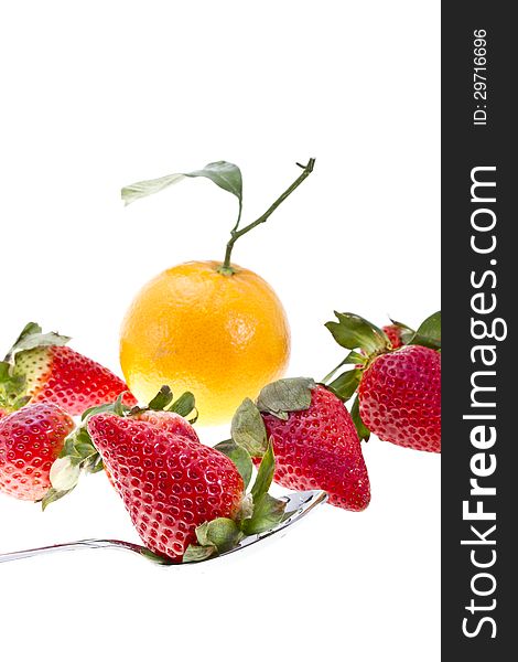 Orange with strawberries and a spoon on white background. Orange with strawberries and a spoon on white background