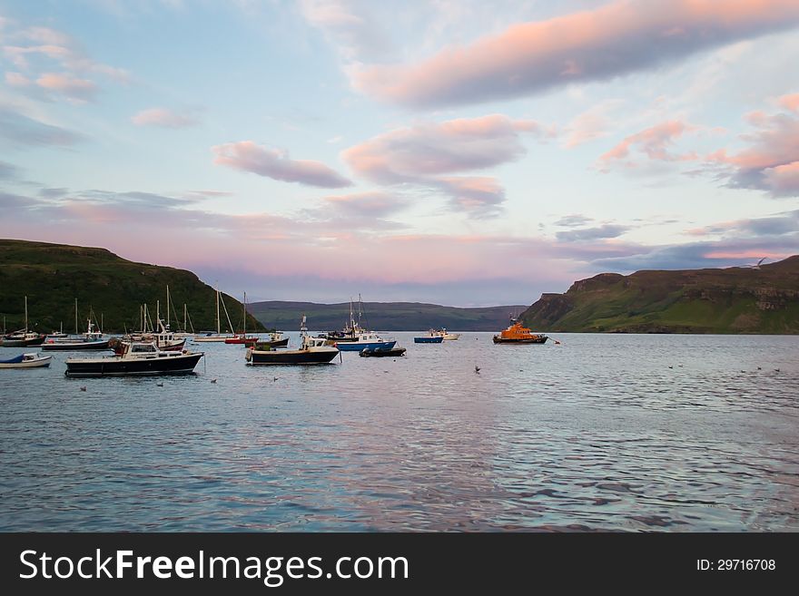 Colorful harbour of Portree in the Skye island, Scotland at the sunset during summer season. Colorful harbour of Portree in the Skye island, Scotland at the sunset during summer season